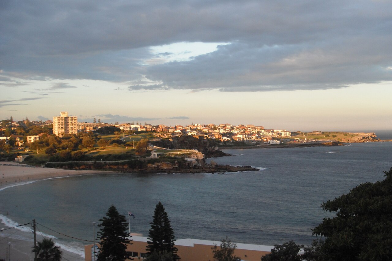 Archive view across Coogee Beach and its headland in Sydney.