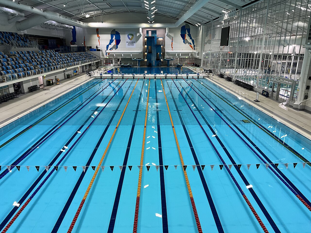 The empty competition pool and spectator seating at Melbourne Sports and Aquatic Centre.