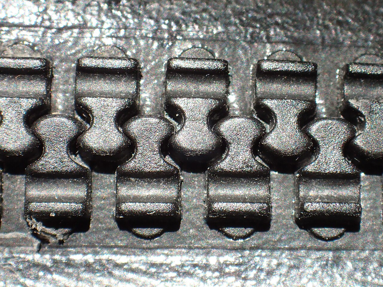 Detailed photograph of the closed teeth of a plastic watertight drysuit zipper