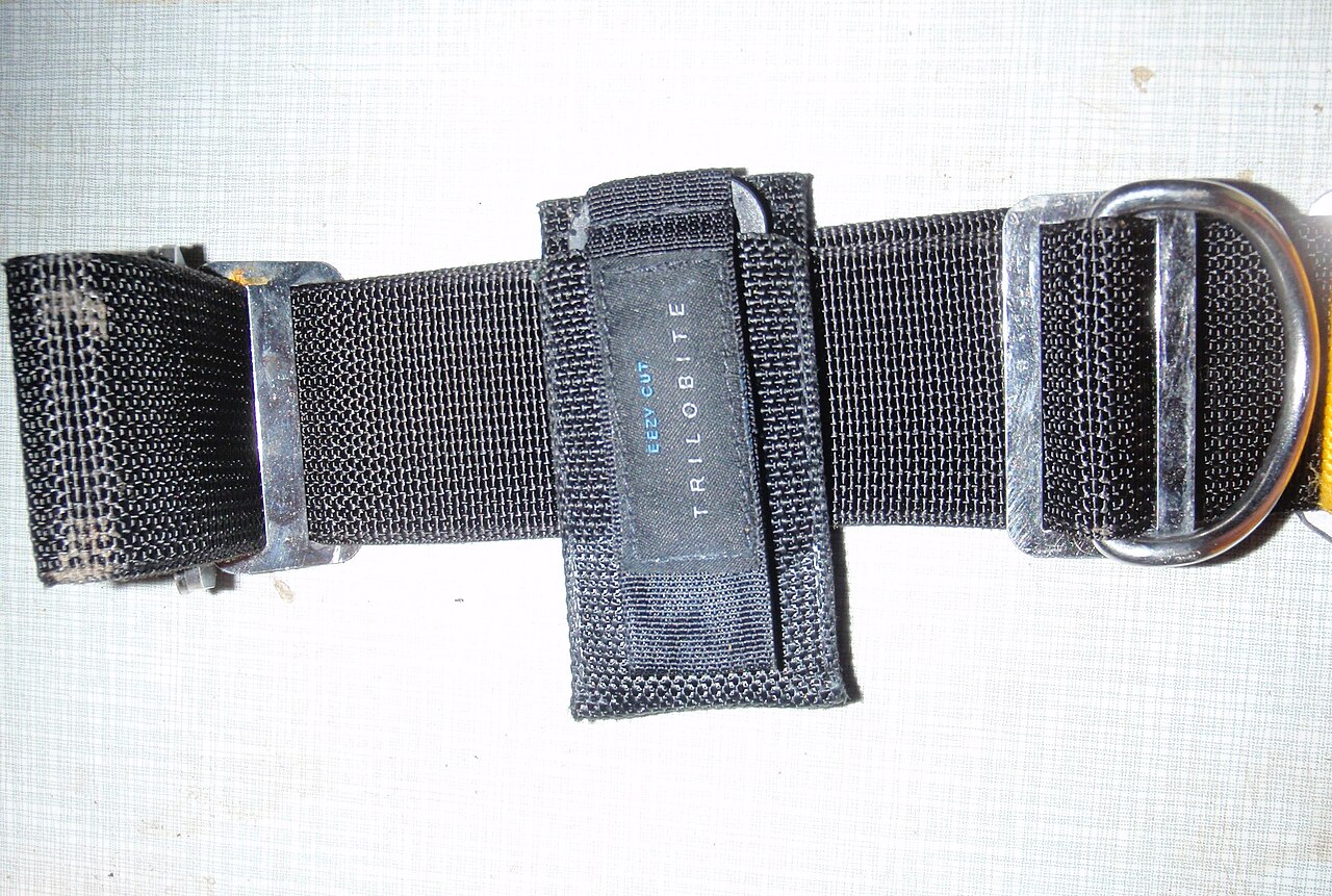 Trilobite line cutter in its sheath attached to diving harness webbing