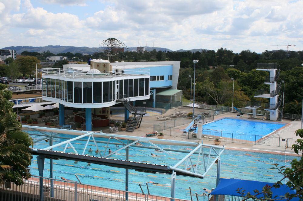 Outdoor swimming lanes, diving tower and pavilion at Centenary Pool Complex in Brisbane.