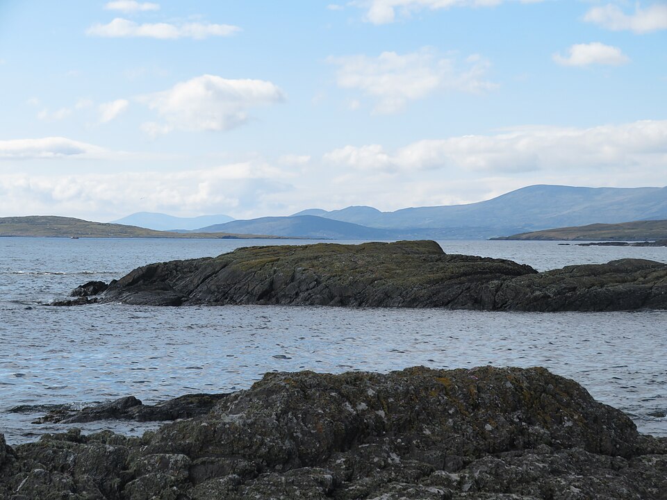 Rocky Eyeries shoreline with sea and distant hills in County Cork