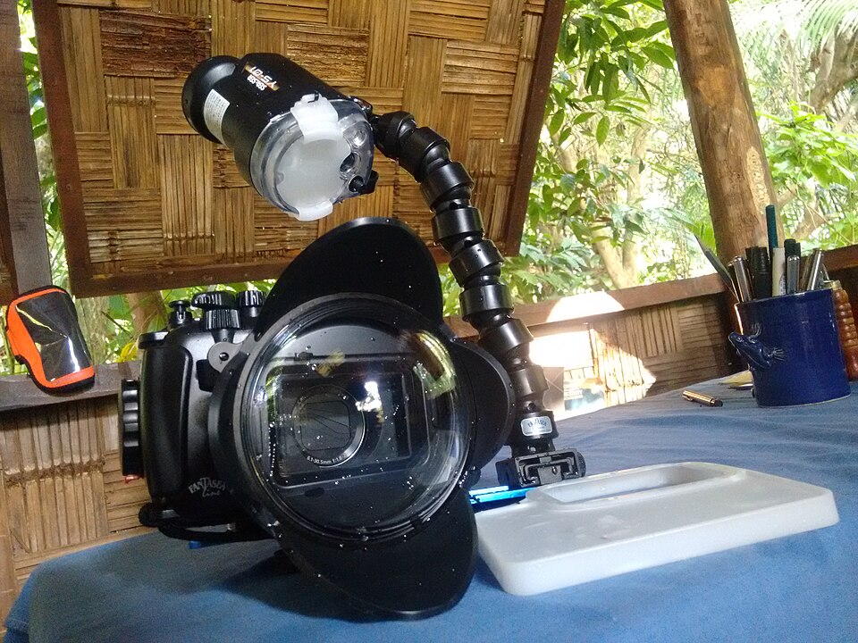A camera in a Fantasea underwater housing with a large front optic and an attached strobe