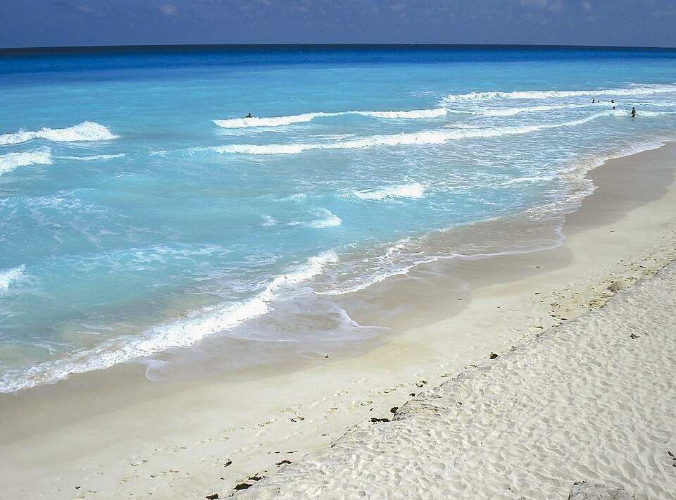 Historical photograph of turquoise sea and sandy shoreline in Cancun, Mexico, in May 2007.
