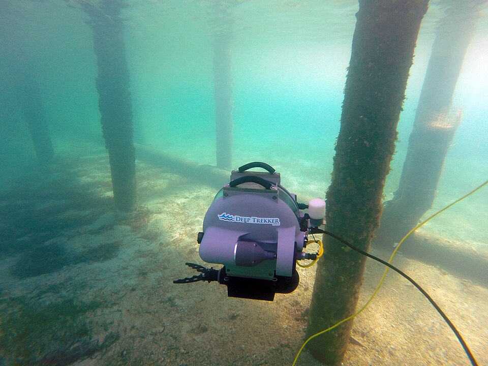 A historical Deep Trekker DTG2 remotely operated vehicle inspecting underwater piles, with its tether visible.