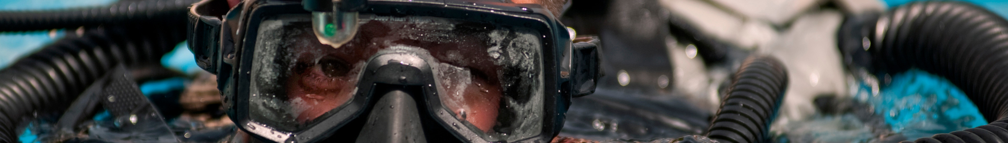 Historical close view of a military diver wearing a mask underwater during training in Bahrain