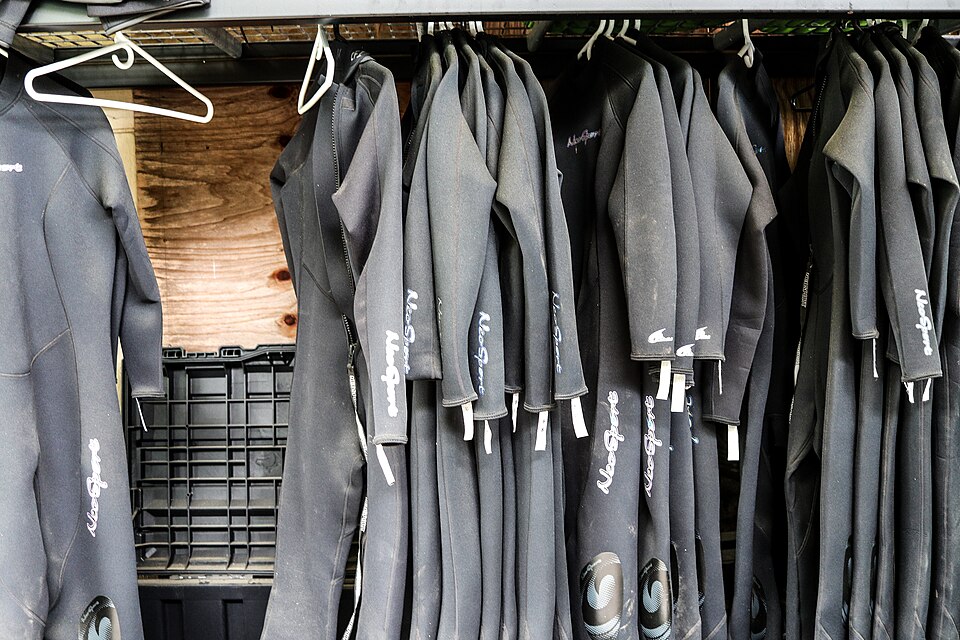 Real photograph of several wetsuits on a rack at a conservation facility near Knoxville in June 2018.