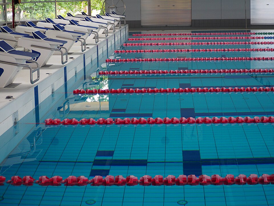 Real photograph of swimming starting blocks and pool lanes at the AIS Training Centre in December 2023.