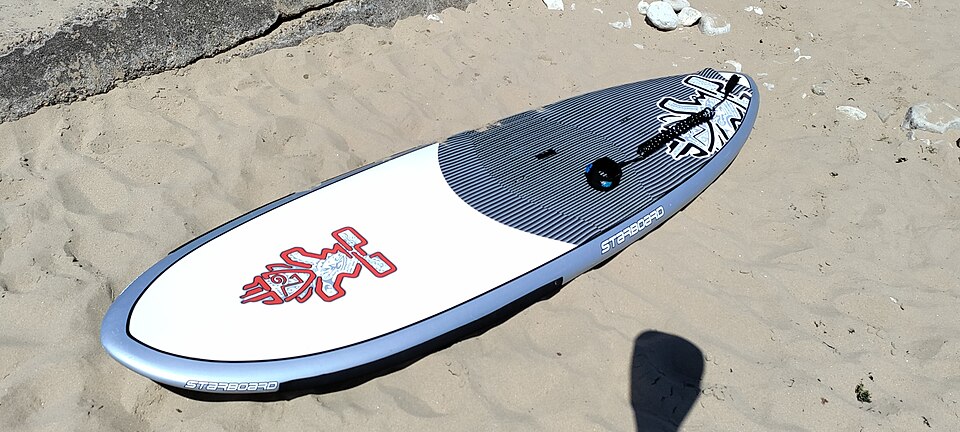 Stand-up paddleboard on sand