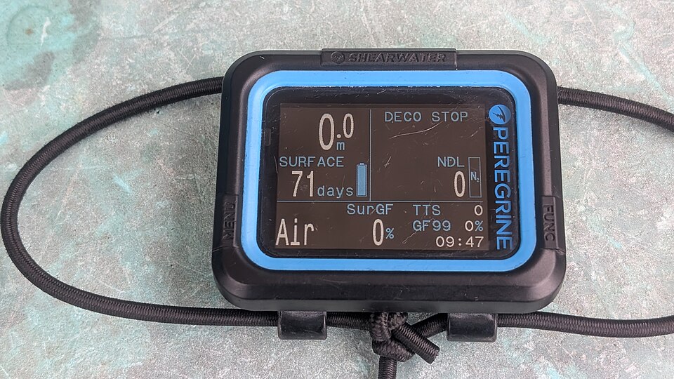 Existing Shearwater Peregrine dive computer resting on a surface, not a battery or charging test.
