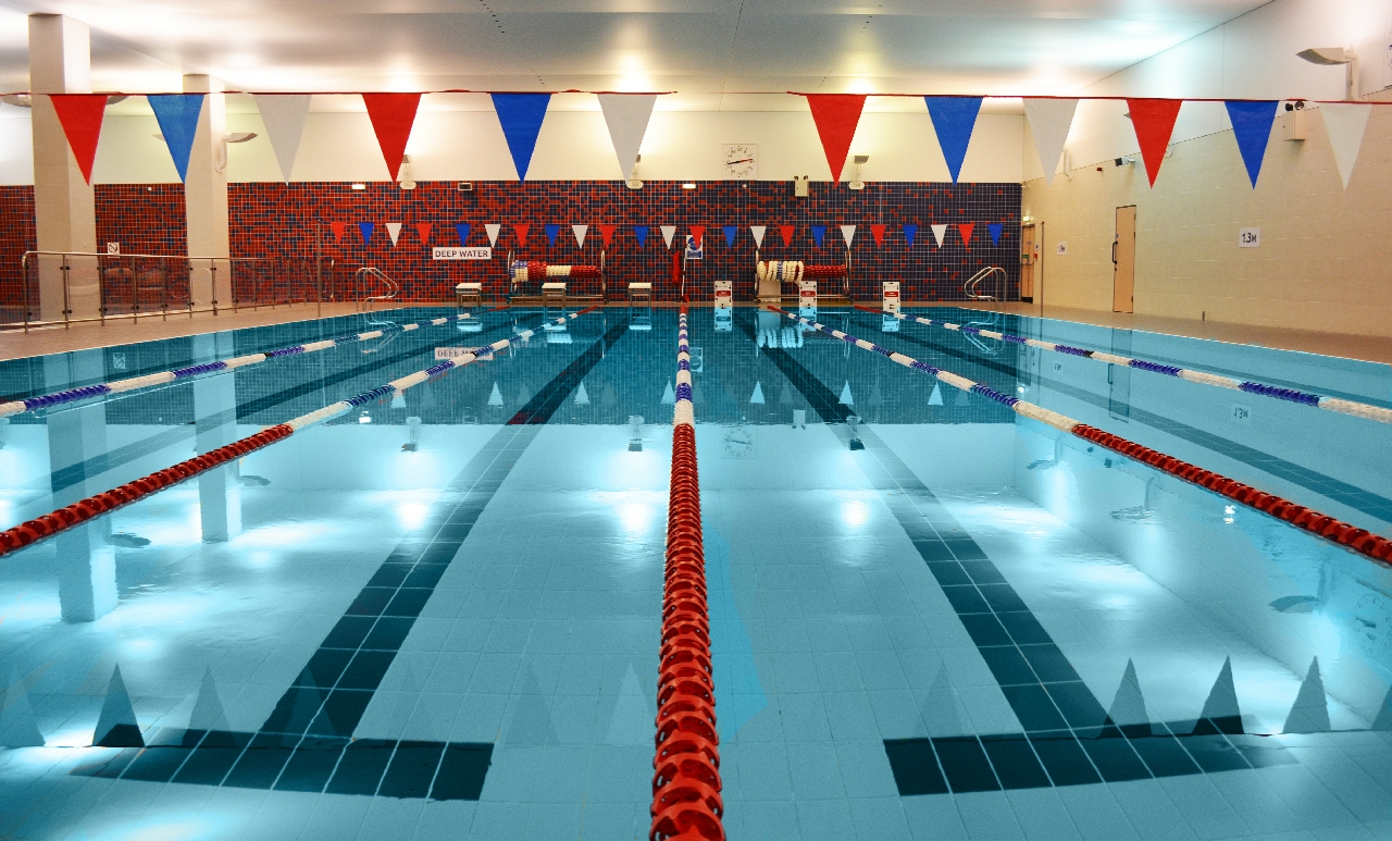 Archive view along the lanes of an empty indoor pool at Basingstoke Sports Centre.