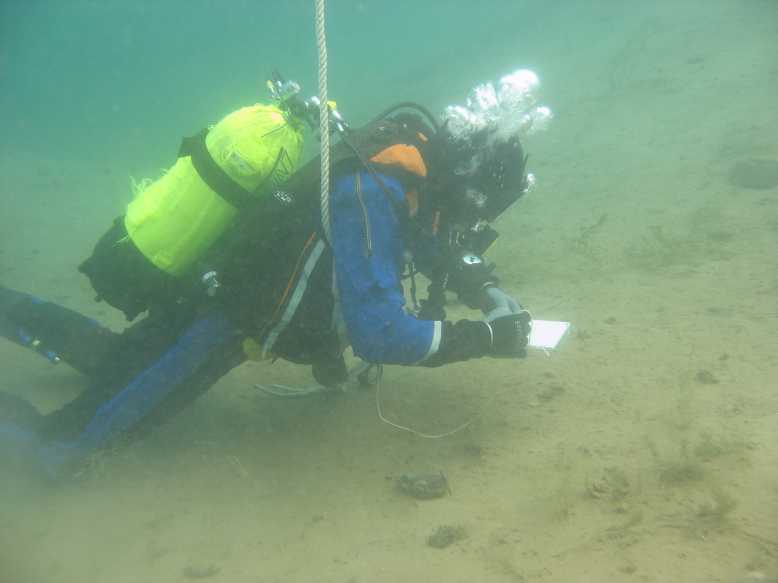 Archived underwater photograph of a scientific diver writing on a small board at Kreidesee Hemmoor.