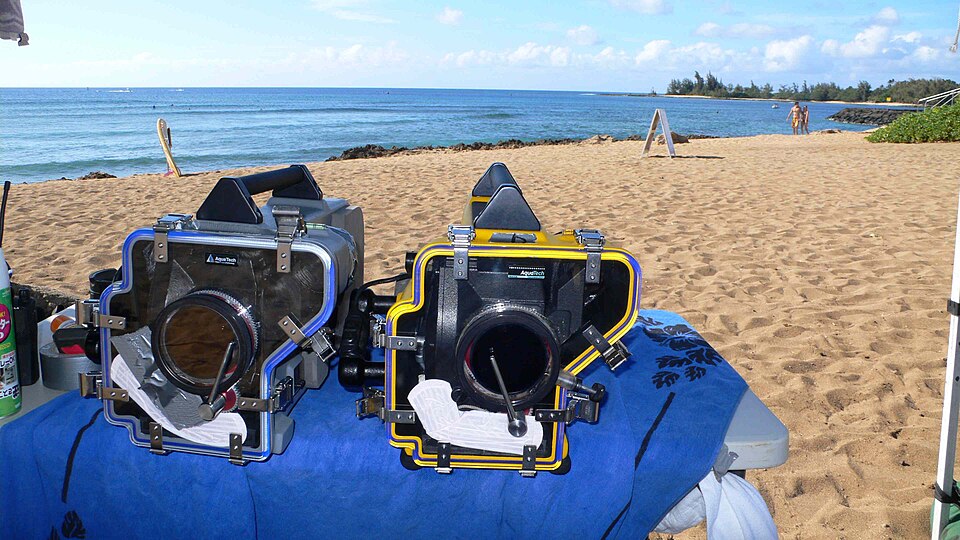 Archive underwater film-camera housings on a beach